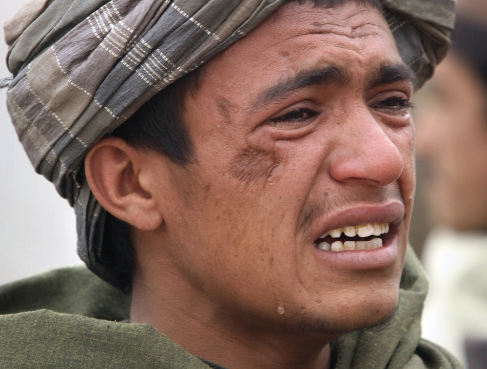 An Afghan youth mourns for relatives who were killed on Sunday.