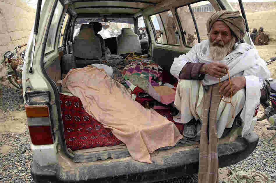 Villagers display the bodies of those allegedly killed when an American soldier opened fire on Afghan civilians. 