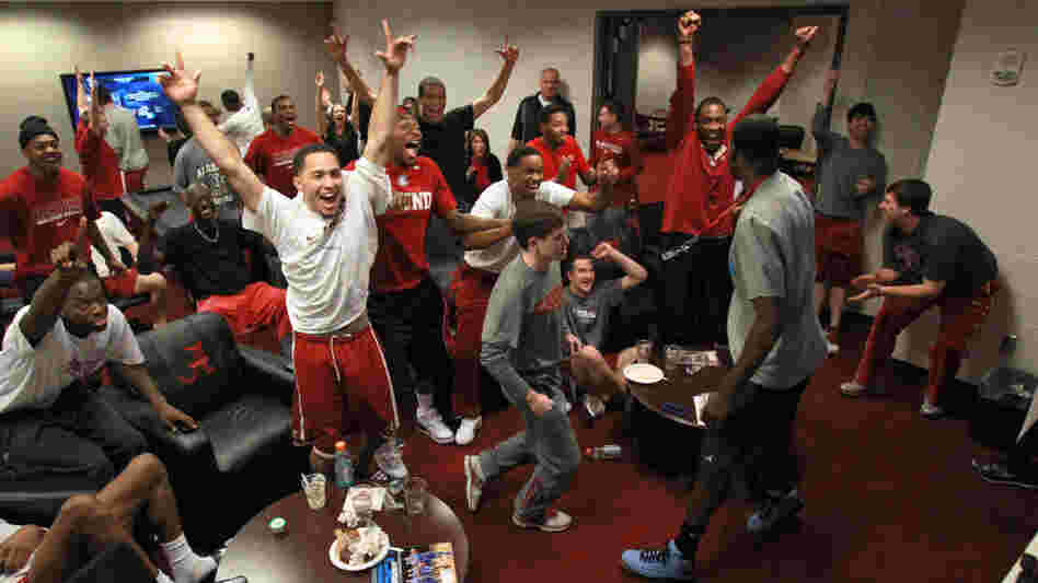 The University of Alabama's players celebrate their No. 8 seeding in the NCAA Men's Basketball Tournament while watching Sunday's selection show in Tuscaloosa. The Crimson Tide, a veteran bunch, will play the upstart mid-major Creighton on Friday.