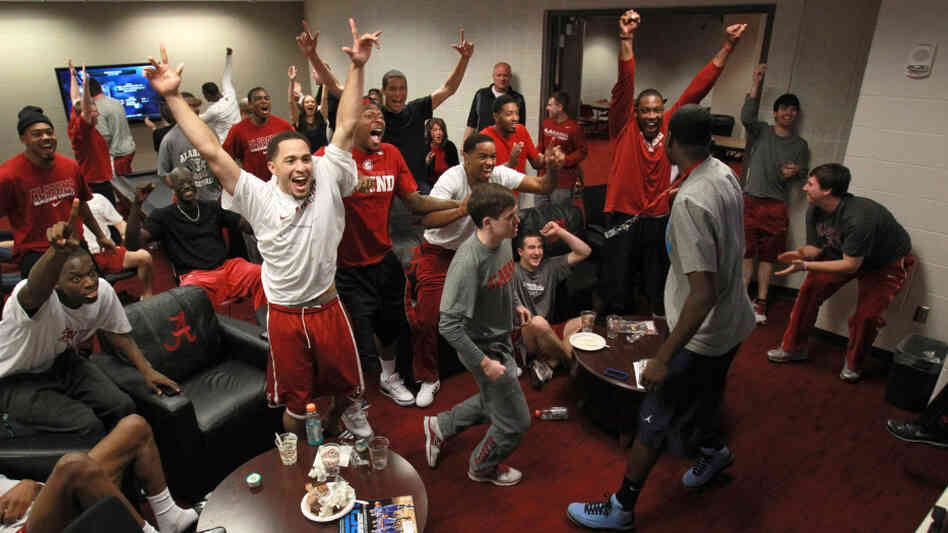 The University of Alabama's players celebrate their No. 8 seeding in the NCAA Men's Basketball Tournament while watching Sunday's selection show in Tuscaloosa. The Crimson Tide, a veteran bunch, will play the upstart mid-major Creighton on Friday.
