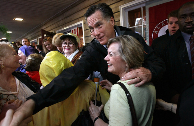 Republican presidential candidate Mitt Romney greets supporters at the Whistle Stop cafe in Mobile, Ala., on Monday, his birthday. 