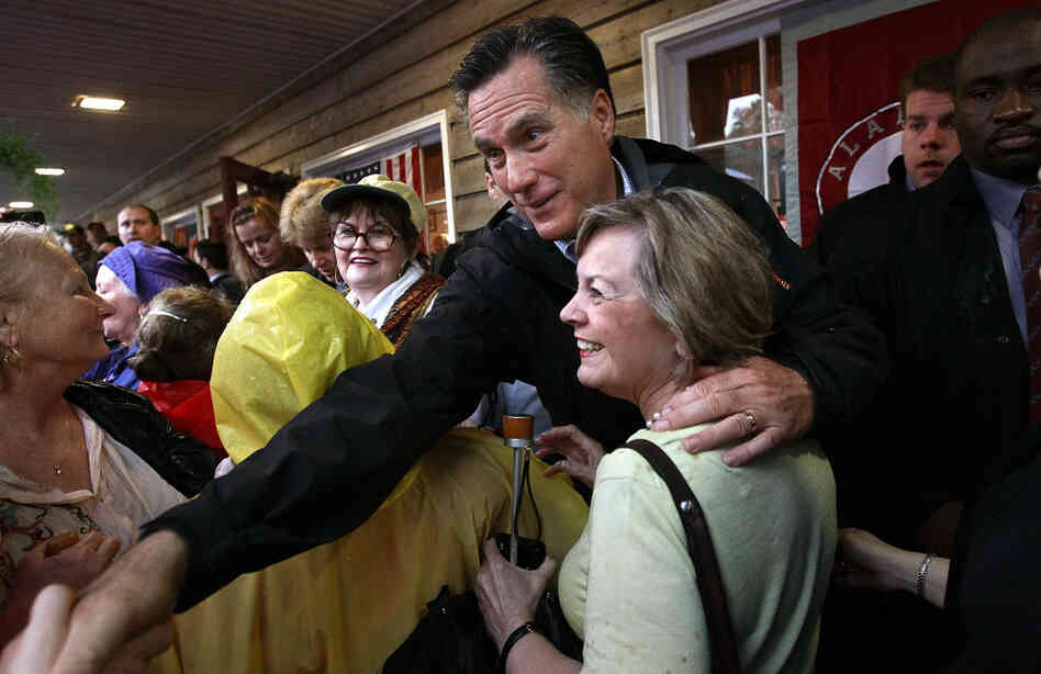 Republican presidential candidate Mitt Romney greets supporters at the Whistle Stop cafe in Mobile, Ala., on Monday, his birthday. 