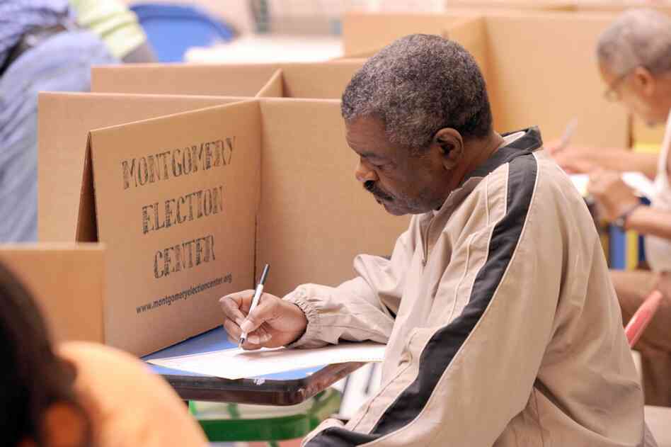 A voter casts his ballot at the Montgomery Museum of Fine Art in Montgomery, Ala. 
