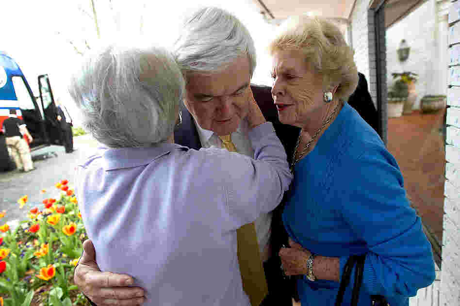 Newt Gingrich is hugged by Helen Smalley (right) and Betty Weeks after speaking to the Vestavia Hills Chamber of Commerce in Birmingham, Ala. 