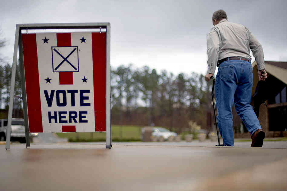 A voter leaves a polling place in Birmingham, Ala. Alabama, Mississippi and Hawaii also held presidential-nominating contests on Tuesday. 