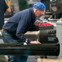  AGCO employees work on the assembly line in the company's newly expanded Jackson, Minn., manufacturing plant. The expansion brought the facility's staff from 850 to 1,050 workers and allows the plant to make tractors that were previously made in France. 