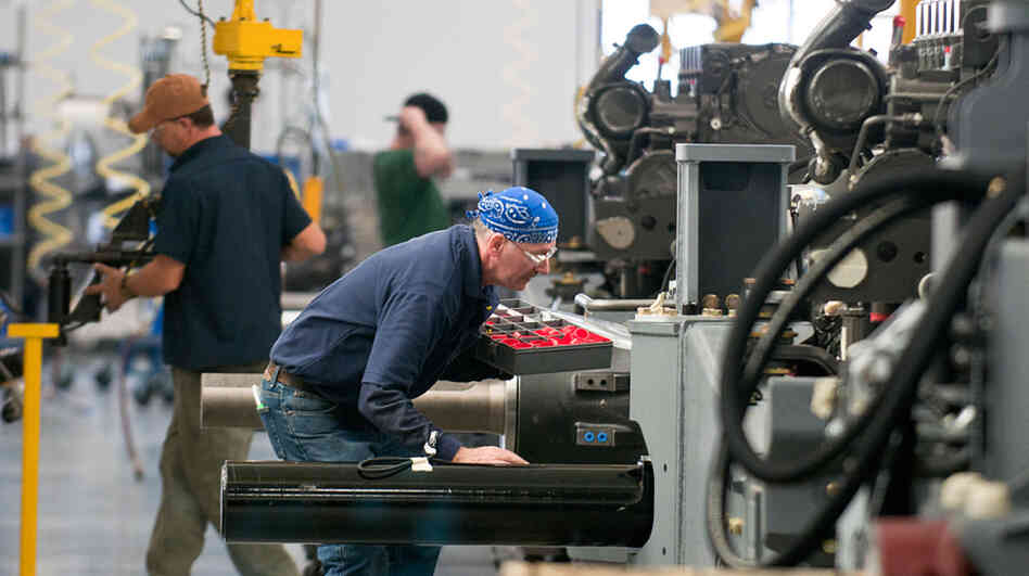 AGCO employees work on the assembly line in the company's newly expanded Jackson, Minn., manufacturing plant. The expansion brought the facility's staff from 850 to 1,050 workers and allows the plant to make tractors that were previously made in France. AGCO employees work on the assembly line in the company's newly expanded Jackson, Minn., manufacturing plant. The expansion brought the facility's staff from 850 to 1,050 workers and allows the plant to make tractors that were previously made in France.