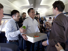 Mitt Romney chats with reporters as he hands out cookies aboard his charter plane, Tuesday, March 13, 2012. Mitt Romney chats with reporters as he hands out cookies aboard his charter plane, Tuesday, March 13, 2012.