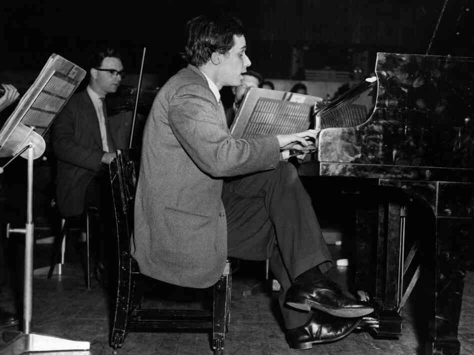A 1959 picture of Glenn Gould rehearsing at London's Royal Festival Hall. (Yes, he's seated on an abnormally short piano stool, hovering only a few inches above the floor.) 