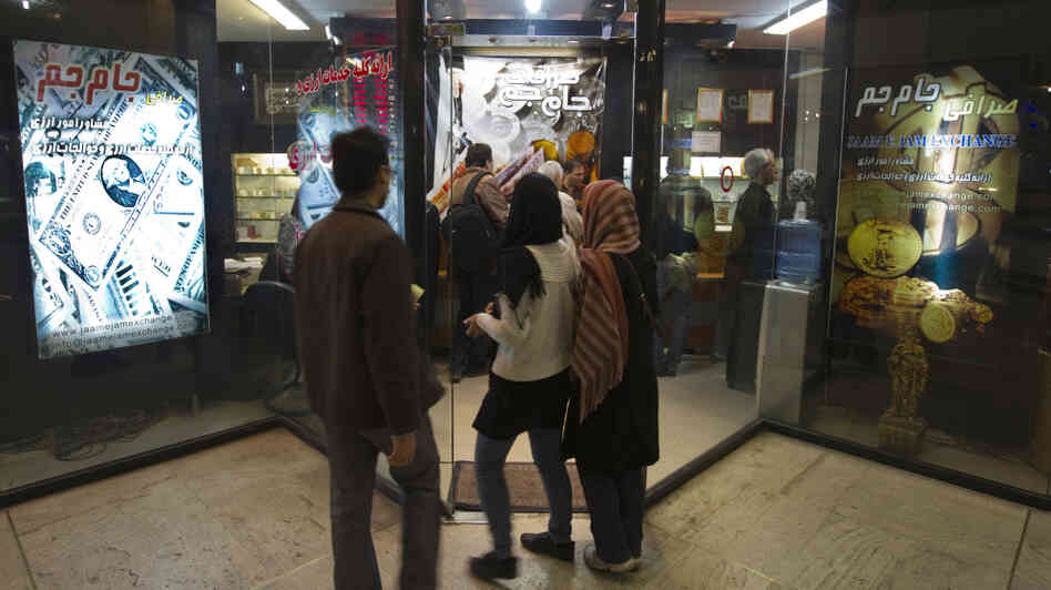 Iranians wait to enter a currency exchange shop in Tehran on Jan. 3. The Iranian rial fell to a record low against the dollar in early January after President Obama signed a bill imposing fresh sanctions on the country's central bank. Iranians wait to enter a currency exchange shop in Tehran on Jan. 3. The Iranian rial fell to a record low against the dollar in early January after President Obama signed a bill imposing fresh sanctions on the country's central bank.