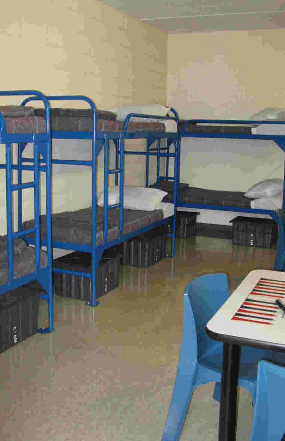 Detainees will sleep eight to a room, with a private bath, and will be permitted to move around the detention center largely unescorted. Detainees will sleep eight to a room, with a private bath, and will be permitted to move around the detention center largely unescorted.