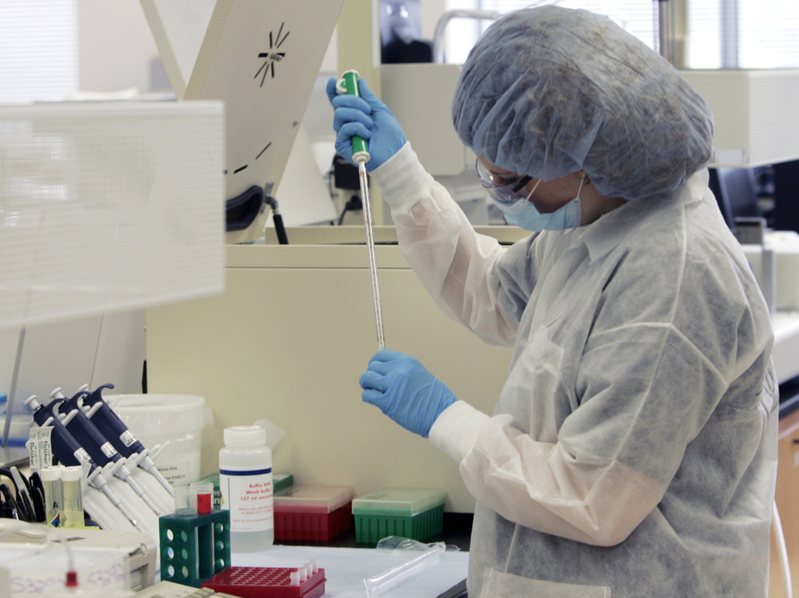  A forensic scientist processes DNA samples at the New York State Police lab in Albany. 