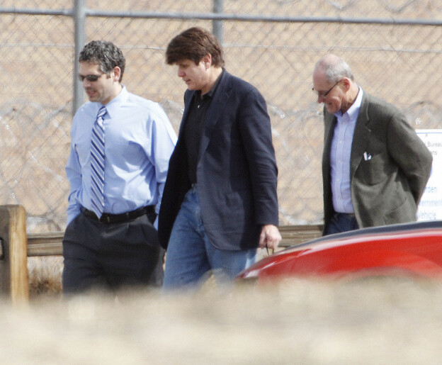 Former Illinois Gov. Rod Blagojevich, center, walks with attorneys as he arrives at the Federal Correctional Institution Englewood in Littleton, Colo., on Thursday.