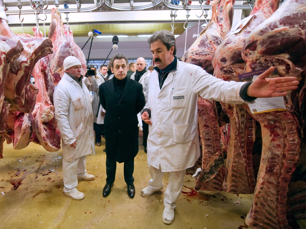 French President Nicolas Sarkozy listens to a butcher during a visit to the butchery pavilion at the Rungis international food market, near Paris, in February. 
