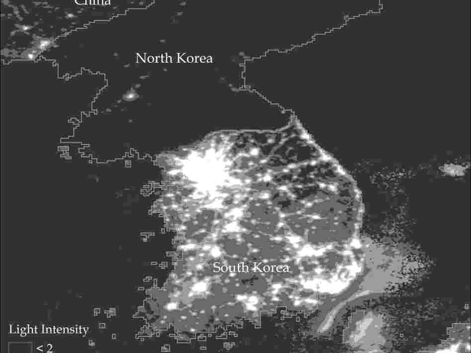 A satellite photo of North and South Korea at night. A satellite photo of North and South Korea at night.