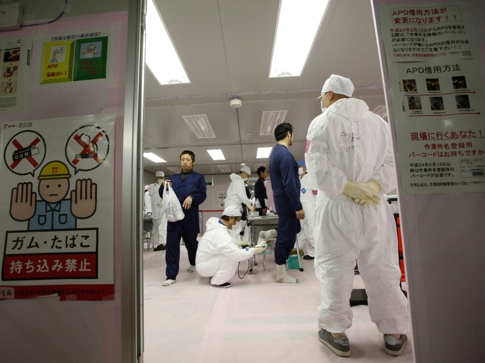 Workers are given radiation screenings as they enter the emergency operation center at Tokyo Electric Power Co.'s Fukushima Dai-Ichi nuclear power plant.