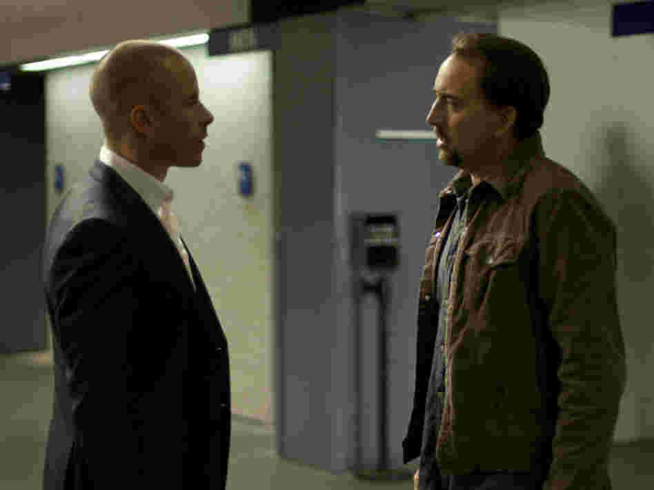 Cage's Gerard improbably accepts an offer from a man known as Simon (Guy Pearce) who knows a bit too much about him and the trauma Gerard's wife has just endured. Cage's Gerard improbably accepts an offer from a man known as Simon (Guy Pearce) who knows a bit too much about him and the trauma Gerard's wife has just endured.