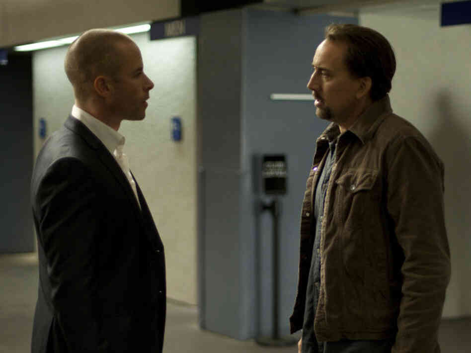 Cage's Gerard improbably accepts an offer from a man known as Simon (Guy Pearce) who knows a bit too much about him and the trauma Gerard's wife has just endured. Cage's Gerard improbably accepts an offer from a man known as Simon (Guy Pearce) who knows a bit too much about him and the trauma Gerard's wife has just endured.
