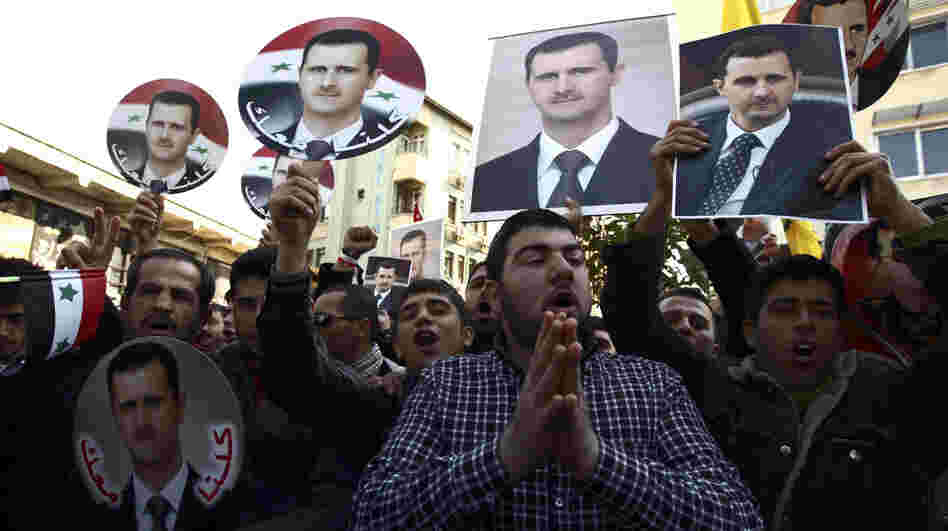 Syrians and Turks show their support for Syrian President Bashar Assad in Turkey's southern city of Antakya on Feb. 19. Assad is a member of the minority Alawite religious sect, and many Alawites on both sides of the border support him. Syrians and Turks show their support for Syrian President Bashar Assad in Turkey's southern city of Antakya on Feb. 19. Assad is a member of the minority Alawite religious sect, and many Alawites on both sides of the border support him.