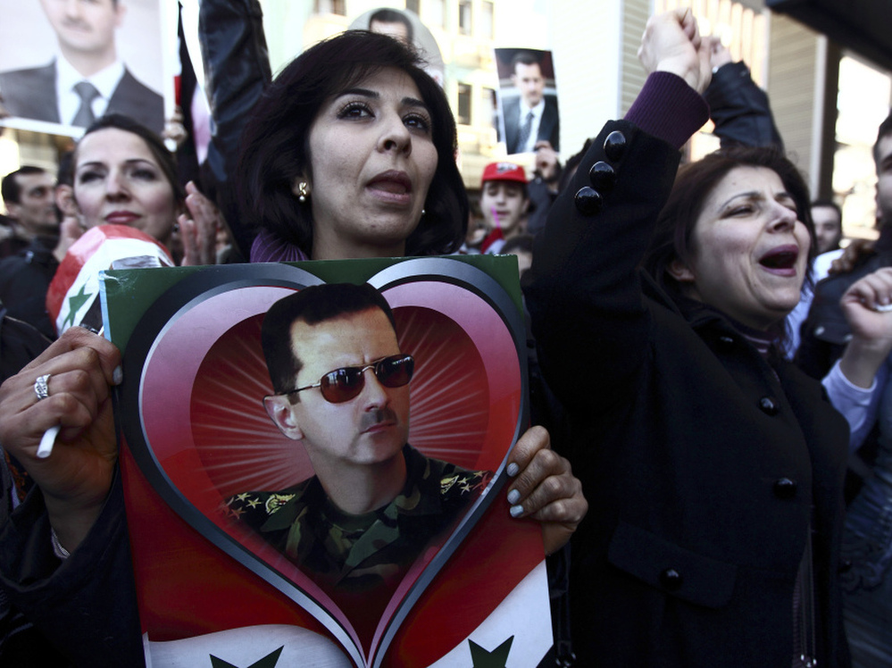 Syrians and Turks show their support for Syria's Assad in Antakya on Feb. 19. Hatay province, where Antakya is located, was once part of Syria.