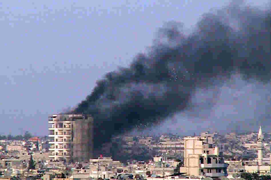 Smoke rises from a building shelled by the Syrian army in Homs on March 9. 
