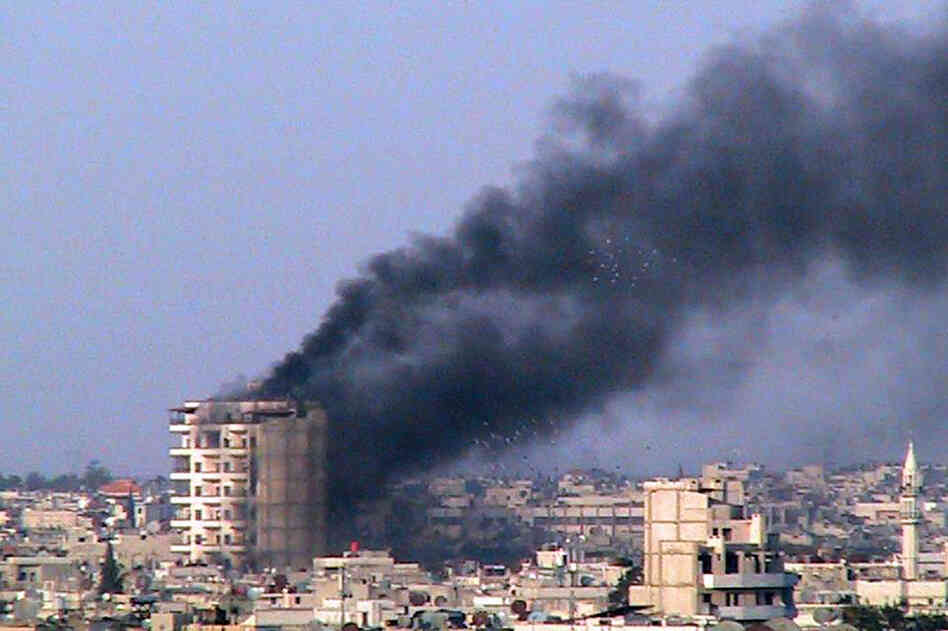 Smoke rises from a building shelled by the Syrian army in Homs on March 9. 