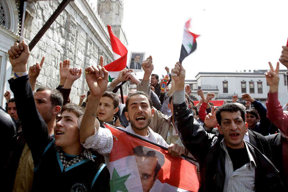 Syrians chant slogans in support of President Bashar Assad during a demonstration in the capital, Damascus, on March 25. 