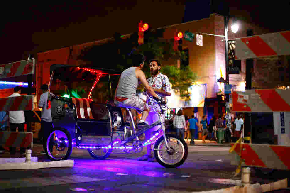 Old and busted: Getting to that Tanlines show by foot. The new hotness: Purple light rickshaws.