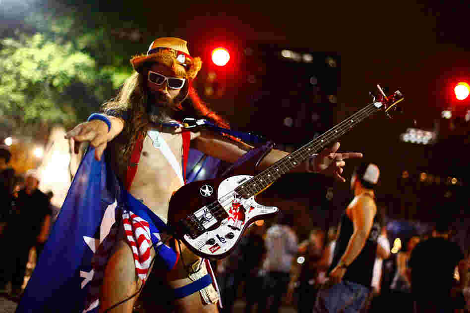 New York City's Naked Cowboy has a little-known cousin in Austin. We didn't catch his name, but we'd like to think it's The Naked Guy Who, For Reasons Of Pure Geography, Could More Likely Be Called An Actual Cowboy.