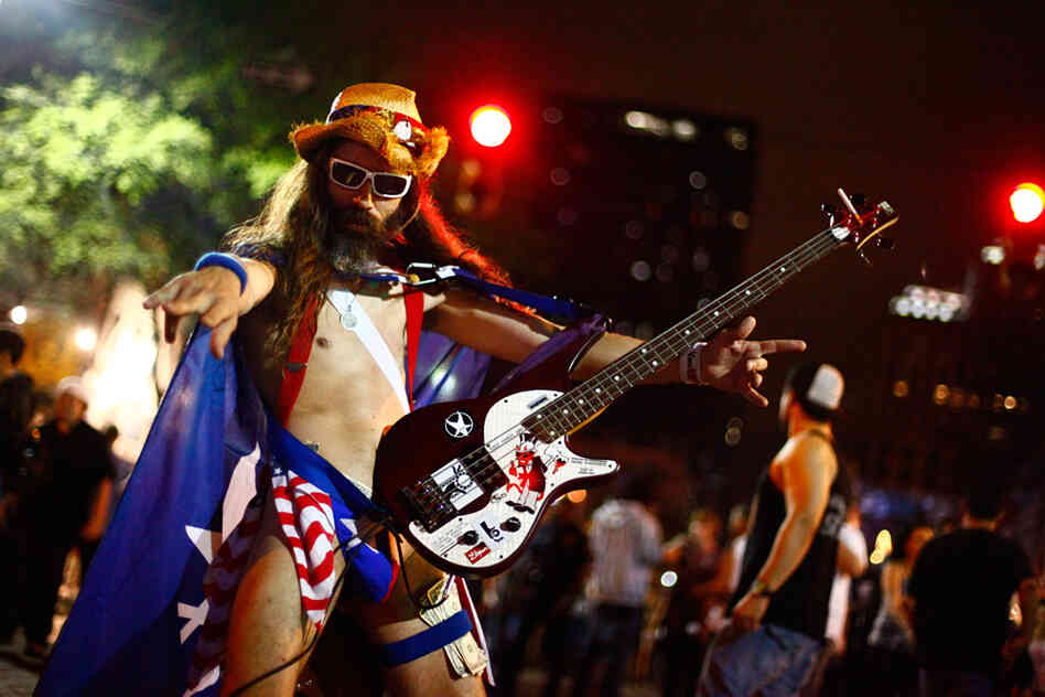 New York City's Naked Cowboy has a little-known cousin in Austin. We didn't catch his name, but we'd like to think it's The Naked Guy Who, For Reasons Of Pure Geography, Could More Likely Be Called An Actual Cowboy.