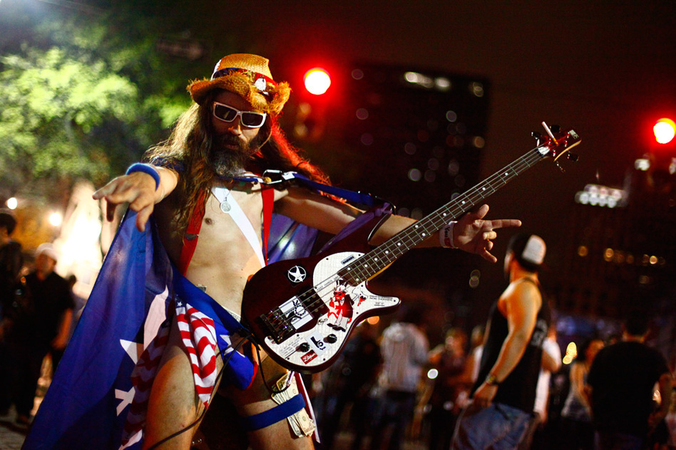 New York City's Naked Cowboy has a little-known cousin in Austin. We didn't catch his name, but we'd like to think it's The Naked Guy Who, For Reasons Of Pure Geography, Could More Likely Be Called An Actual Cowboy.