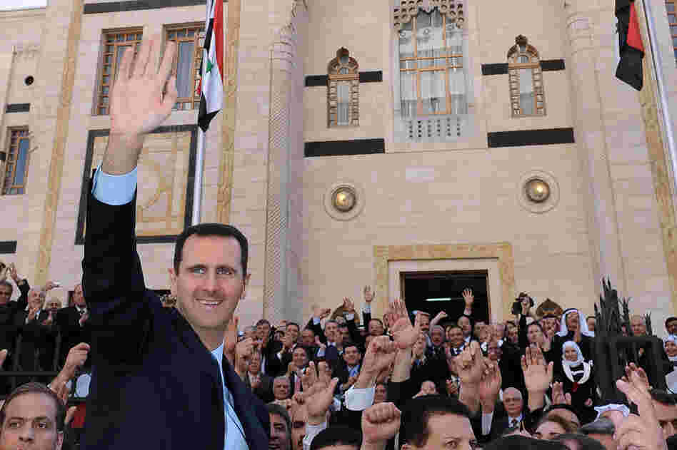 President Assad waves to supporters after a speech at the parliament in Damascus on March 30. 