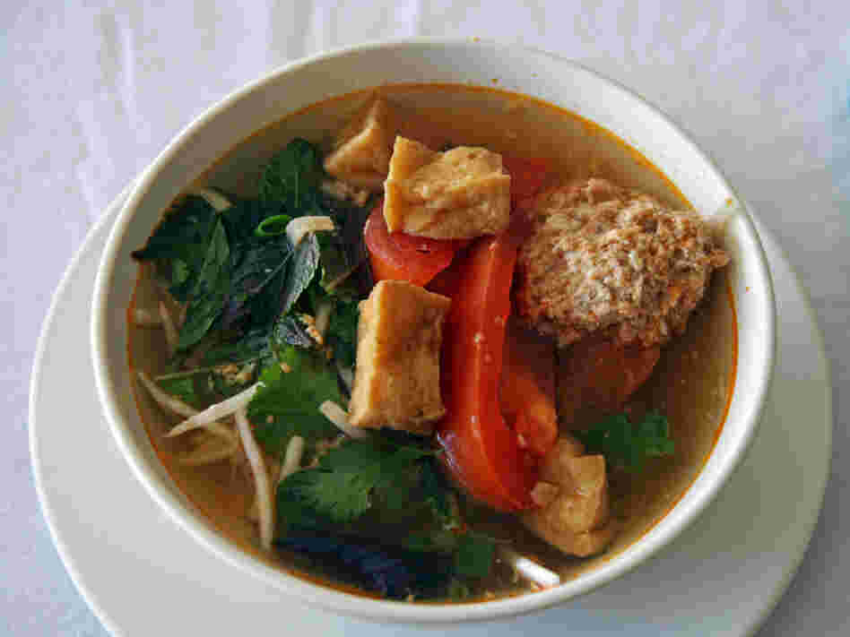 Linh Nguyen's Vietnamese soup features fried tofu, tomatoes, a scattering of fresh herbs and some delicate poached crab and pork dumplings.