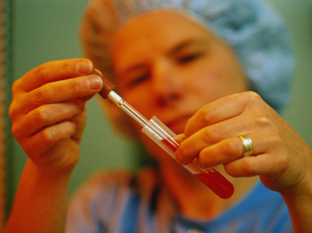 A technician places a fertilized human egg in a test tube. New technology has led to new legal questions: What happens to survivors benefits when a baby is conceived after a father's death? 