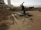 A Palestinian youth breaks up stones for construction in Gaza City. Despite restrictions on imports including building material, the area is going through a construction boom. A Palestinian youth breaks up stones for construction in Gaza City. Despite restrictions on imports including building material, the area is going through a construction boom.