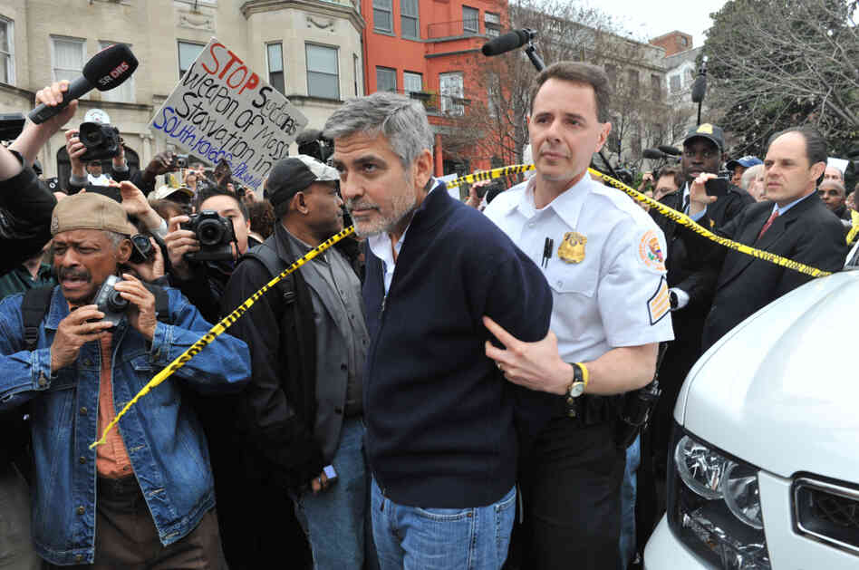 Actor George Clooney is led away in handcuffs from Sudan's embassy in Washington, D.C., on Friday. Clooney, his father, Nick, and others including Democratic Rep. Jim Moran of Virginia and NAACP President Ben Jealous, were arrested as they demonstrated to bring attention to the humanitarian crisis in Sudan. Actor George Clooney is led away in handcuffs from Sudan's embassy in Washington, D.C., on Friday. Clooney, his father, Nick, and others including Democratic Rep. Jim Moran of Virginia and NAACP President Ben Jealous, were arrested as they demonstrated to bring attention to the humanitarian crisis in Sudan.