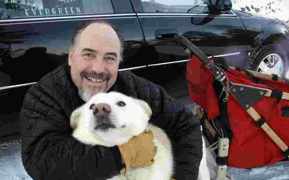 Iditarod Trail Sled Dog Race rookie Scott Janssen, known as the "Mushing Mortician," of Anchorage, Alaska, poses for a photo with one of his pet dogs. 