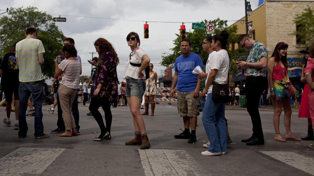 Eventual concertgoers at SXSW wait in line along 6th Street in Austin, Texas.