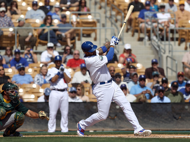 Matt Kemp of the Los Angeles Dodgers hits a RBI single against the Oakland Athletics during a spring training game at Camelback Ranch on March 8 in Glendale, Ariz.