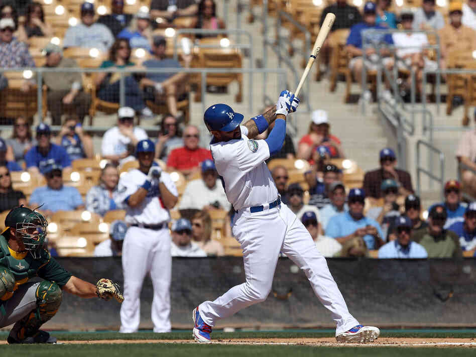 Matt Kemp of the Los Angeles Dodgers hits a RBI single against the Oakland Athletics during a spring training game at Camelback Ranch on March 8 in Glendale, Ariz.
