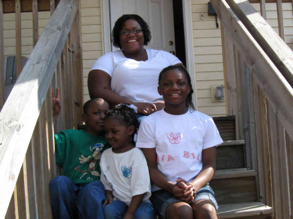 Tamika Rhodes and her children (clockwise) Taneea, Takeema and Paul at their home in St. Paul, Minn. Rhodes says the house is more important to her as a source of stability than as an investment.