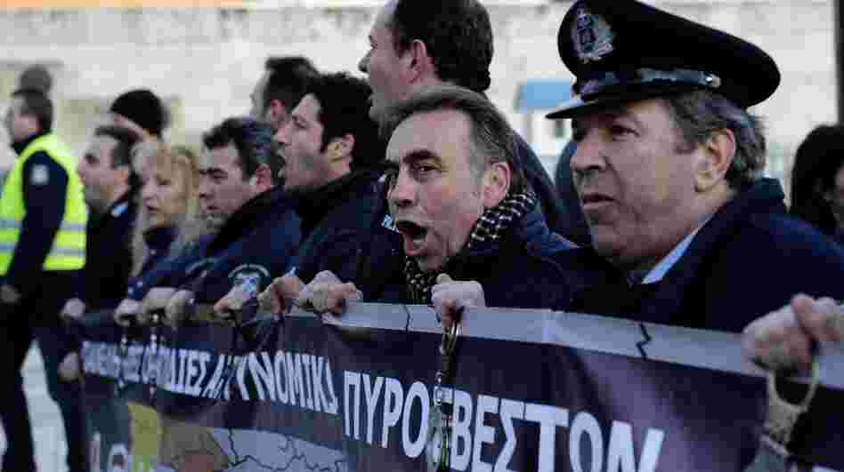 Policemen shout slogans during a demonstration of Greek security forces against the new austerity measures in Athens. Policemen shout slogans during a demonstration of Greek security forces against the new austerity measures in Athens.