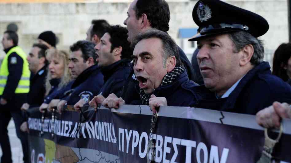 Policemen shout slogans during a demonstration of Greek security forces against the new austerity measures in Athens. Policemen shout slogans during a demonstration of Greek security forces against the new austerity measures in Athens.