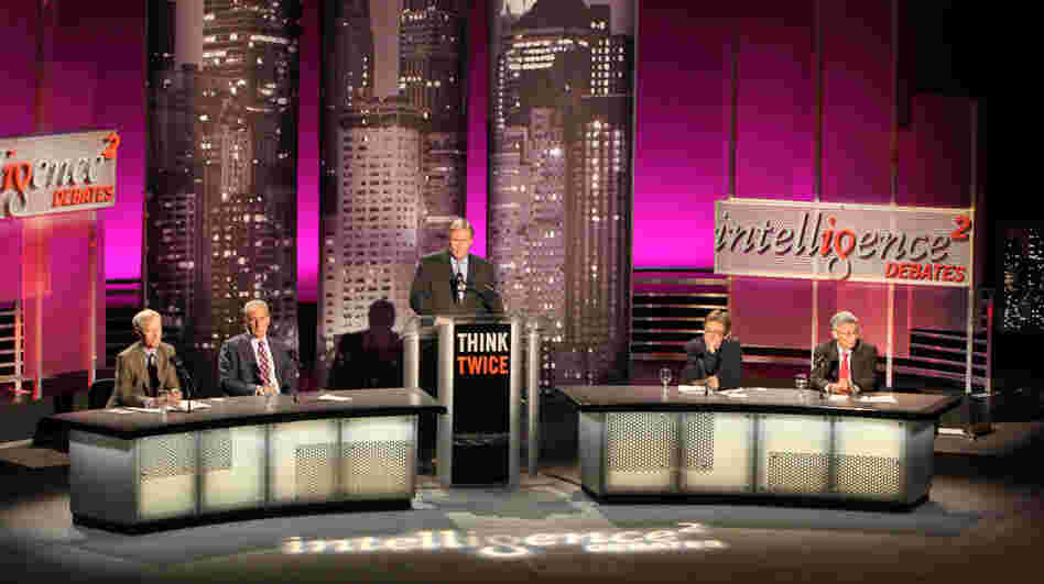 Orville Schell (from left), Peter Schiff, moderator John Donvan, Ian Bremmer and Minxin Pei speak before an audience in New York on the motion "China Does Capitalism Better Than America."