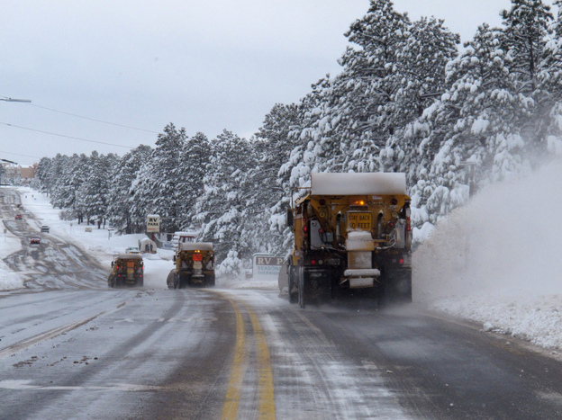 A line of snow plows clears a street on Monday in Flagstaff, Ariz. Heavy snow and high winds struck parts of Arizona on Sunday, causing hazardous driving conditions and school cancellations Monday. 