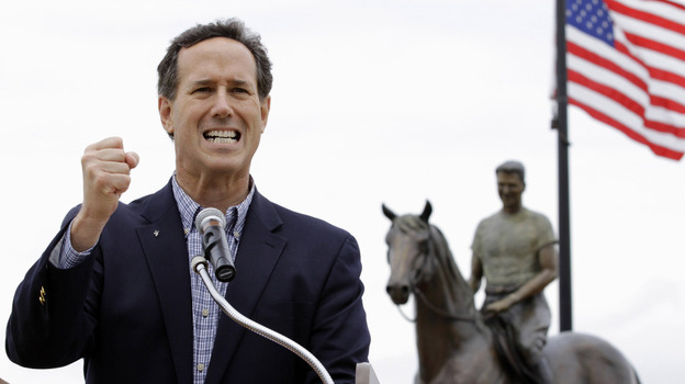 Standing in front of a statue of Ronald Reagan on horseback, Rick Santorum speaks at a campaign rally Monday in Dixon, Ill. 