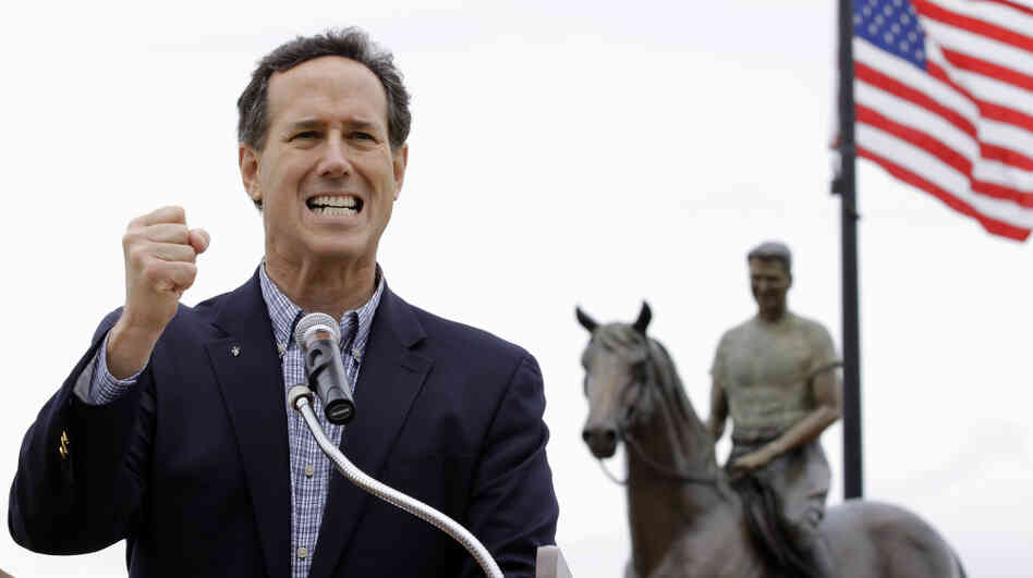 Standing in front of a statue of Ronald Reagan on horseback, Rick Santorum speaks at a campaign rally Monday in Dixon, Ill. 