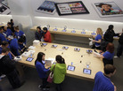 Customers talk with Apple employees, in blue, inside a San Francisco Apple store on Friday, the first day of the launch of the new iPad. Customers talk with Apple employees, in blue, inside a San Francisco Apple store on Friday, the first day of the launch of the new iPad.