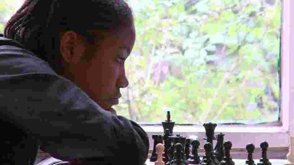 Rochelle, one of the kids in Brooklyn Castle, examines a chess board. Rochelle, one of the kids in Brooklyn Castle, examines a chess board.