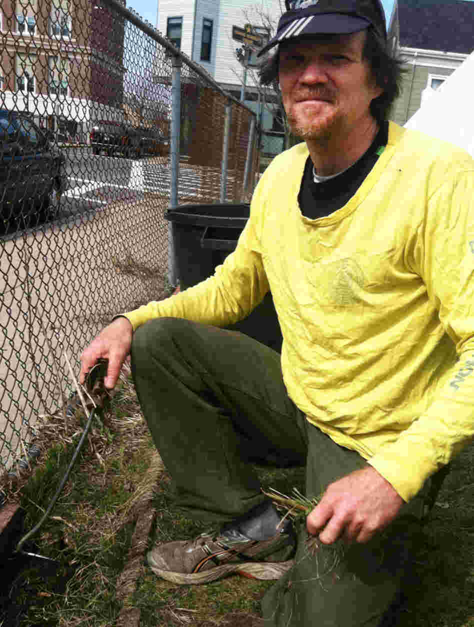 Handyman Peter Brook, 51, pulls weeds outside his church in Boston. Before 2006, Brook says, he couldn't afford health care.